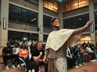 a man wearing a mask in front of an audience